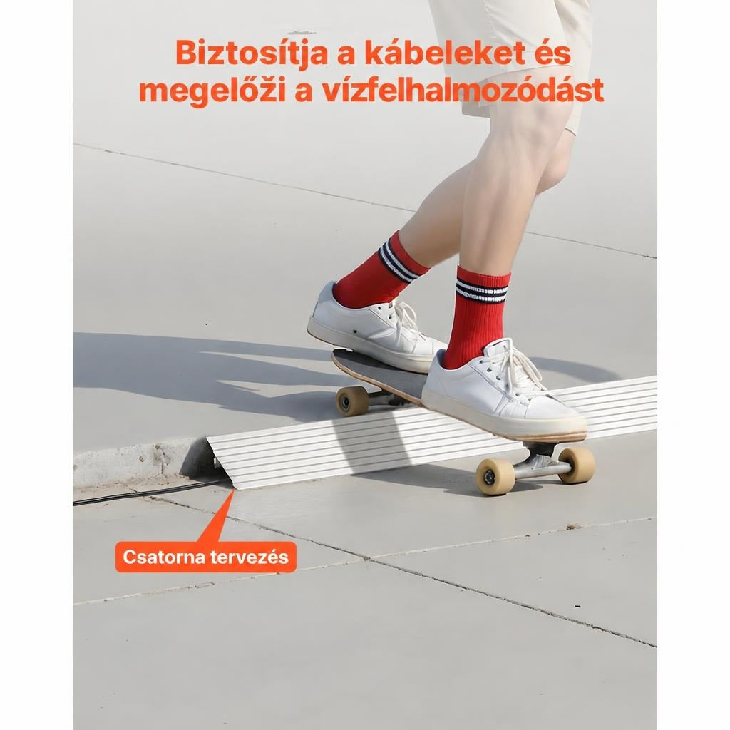 Gördeszkás áthaladása a földre helyezett kábelvédő rámpán.
