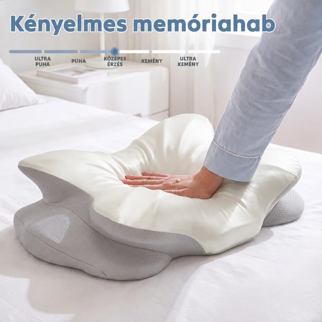 Kéz nyomja össze a kényelmes, közepes keménységű memóriahabos párnát az ágyon.