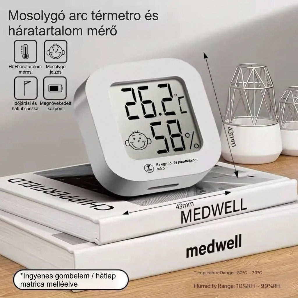 Medwell digitális mini szobai hőmérő és páratartalom-mérő kijelzővel, könyvekre helyezve.