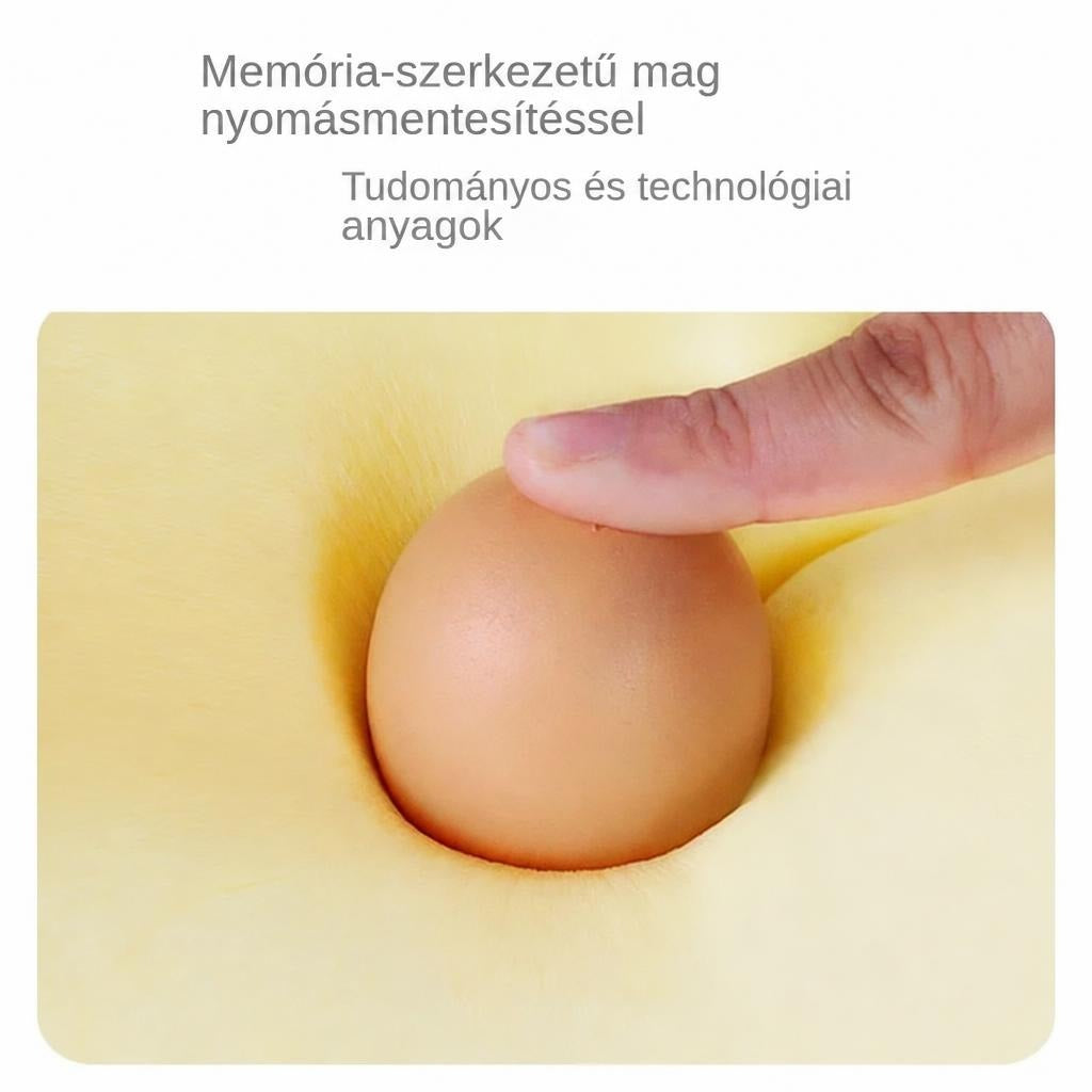 Ujj nyom egy tojást a puha memóriahabba, bemutatva a nyomásmentesítő anyagot.