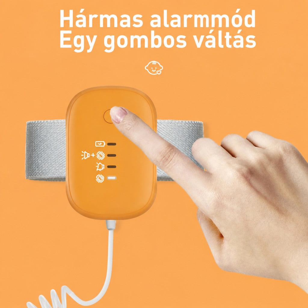 Narancssárga színű vizeletriasztó készülék karszalaggal és bekapcsoló gombbal.